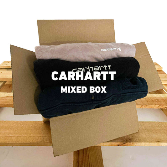 Carhartt Mixed Box | Vintagebulk met diverse vintage Carhartt kledingstukken in een open kartonnen doos op houten pallet, ideaal voor groothandel.